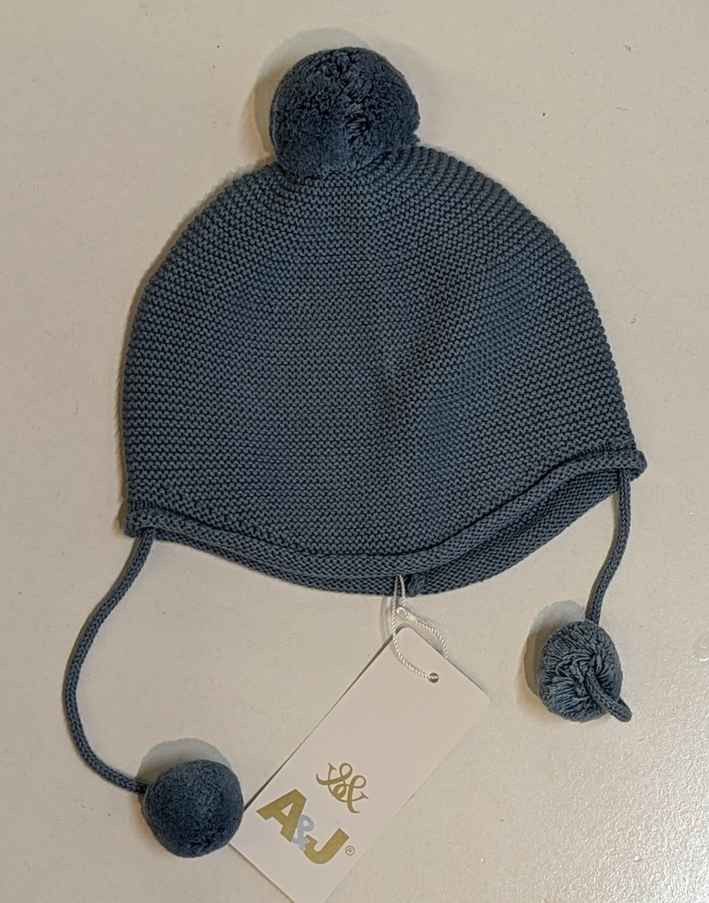 AJ288 Gorro bebé liso com pompones